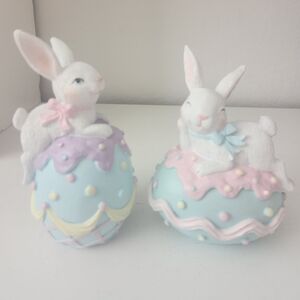 Easter Bunny Resin Figurines Laying On Top Of Pastel Eggs Set Of 2